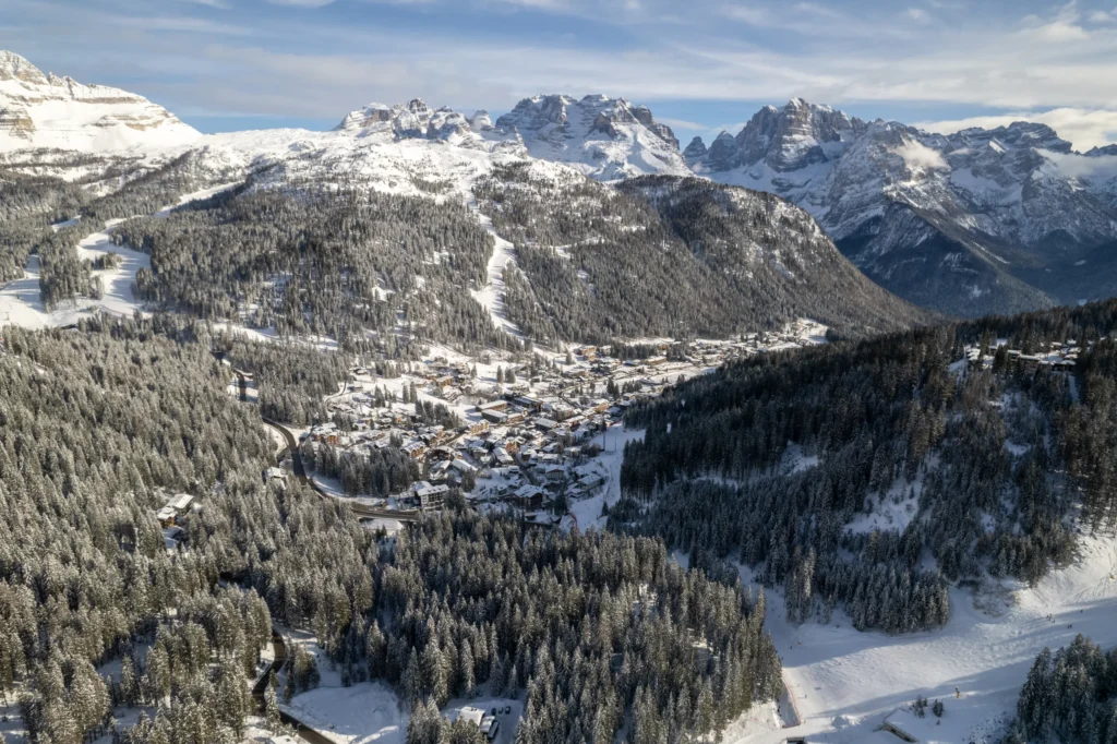 Madonna di Campiglio dall'alto dopo una nevicata, con le Dolomiti di Brenta sullo sfondo