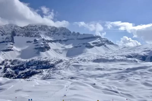 Snow-covered mountains under a clear blue sky.